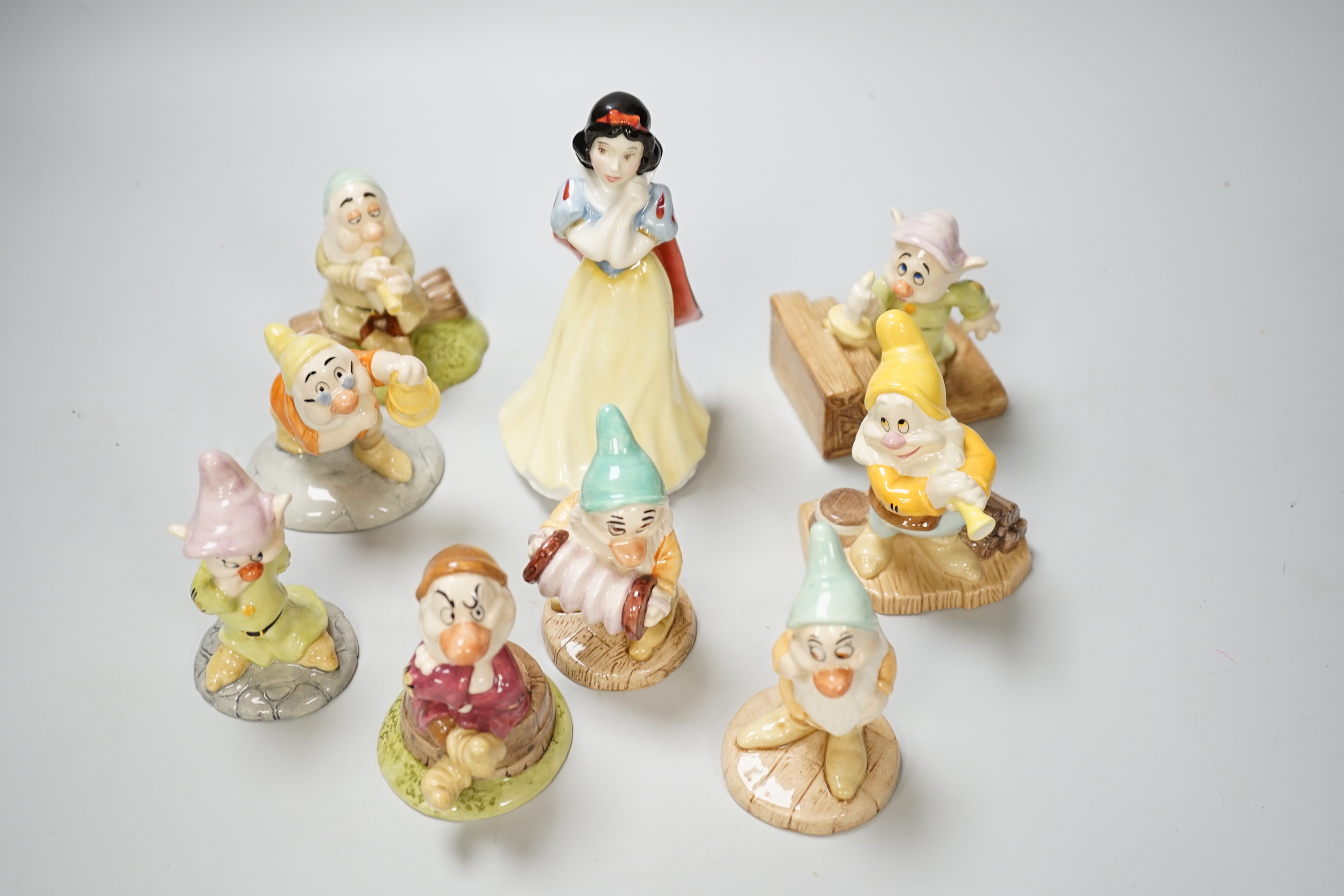 A set of Royal Doulton figures of Snow White and seven dwarves, 15cm, two versions of Dopey (9)